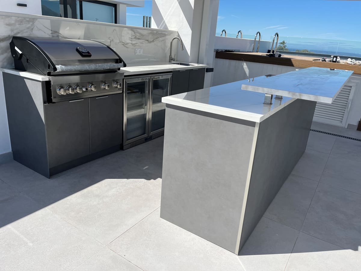 Rooftop outdoor kitchen with island and sea view